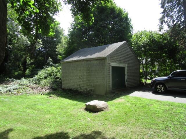 view of outbuilding featuring a lawn