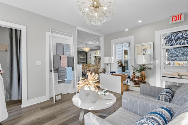 living room featuring wood-type flooring and a notable chandelier