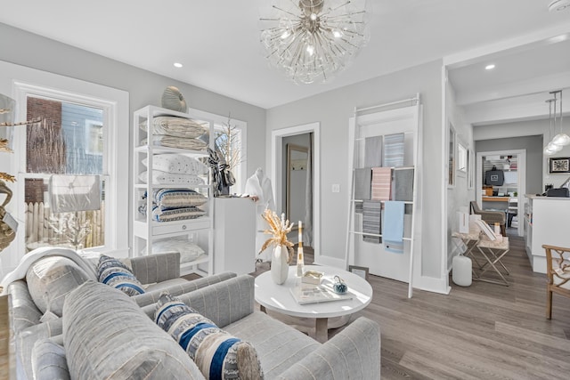 living room featuring an inviting chandelier and hardwood / wood-style floors