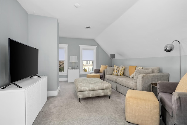 carpeted living room featuring vaulted ceiling