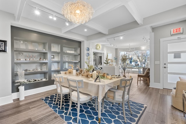 dining room with hardwood / wood-style flooring, beam ceiling, a chandelier, and built in features