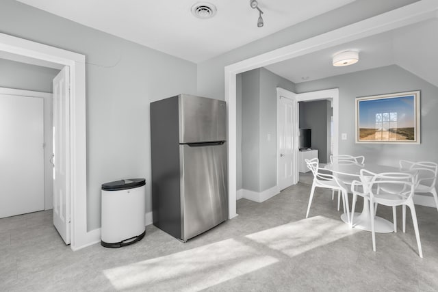 kitchen featuring stainless steel refrigerator and light carpet