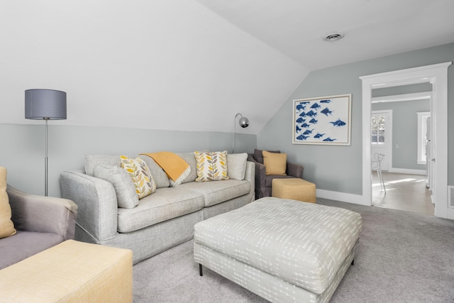 living room with lofted ceiling and light colored carpet