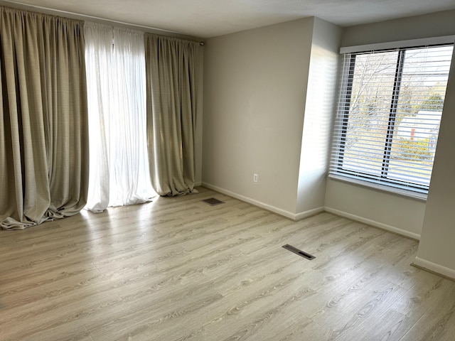 spare room with light hardwood / wood-style flooring