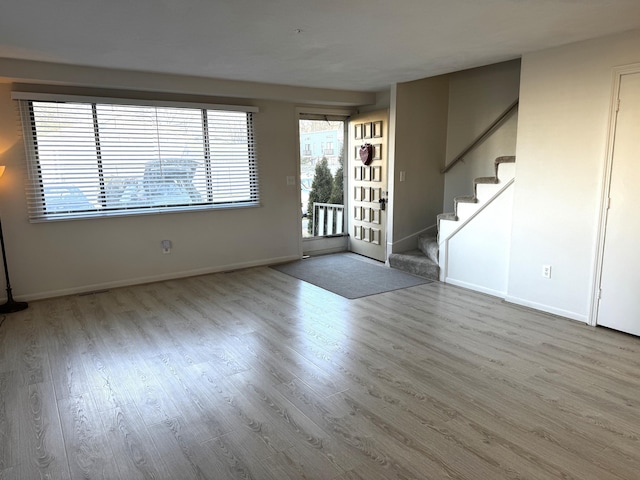 spare room with light hardwood / wood-style flooring and a wealth of natural light