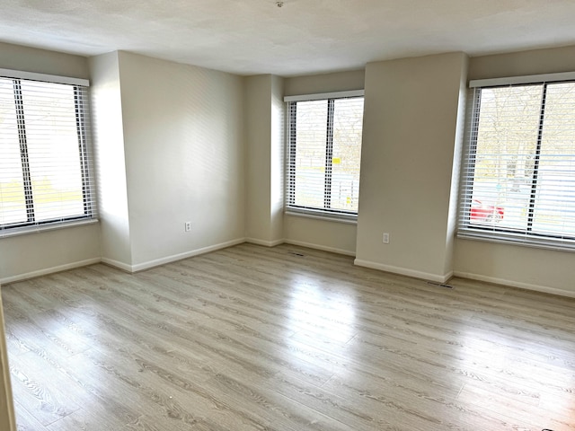 spare room featuring light hardwood / wood-style floors