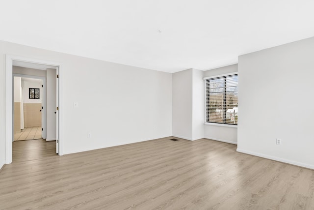 unfurnished room with light wood-style flooring