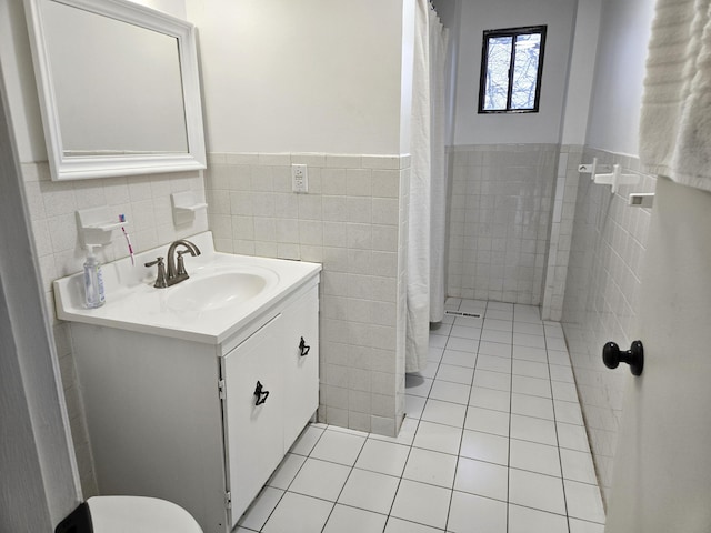 bathroom featuring tile patterned floors, tile walls, and vanity