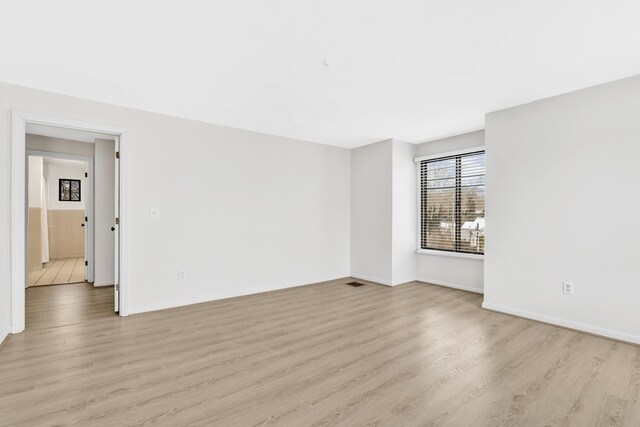 empty room with light wood finished floors