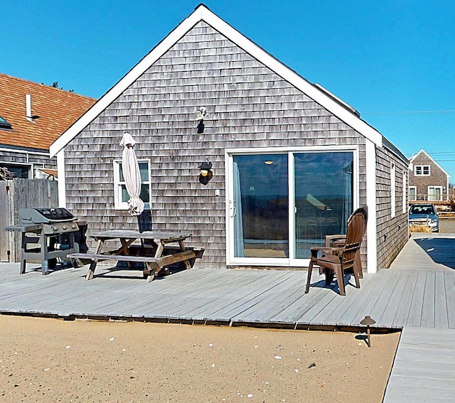 rear view of property featuring a wooden deck