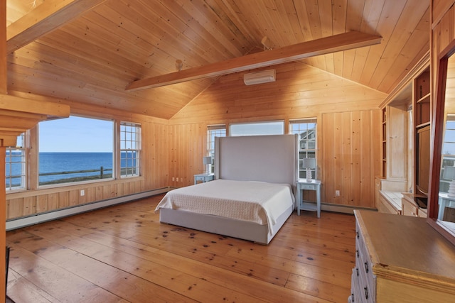 bedroom featuring wooden walls, baseboard heating, light wood-type flooring, a water view, and lofted ceiling with beams