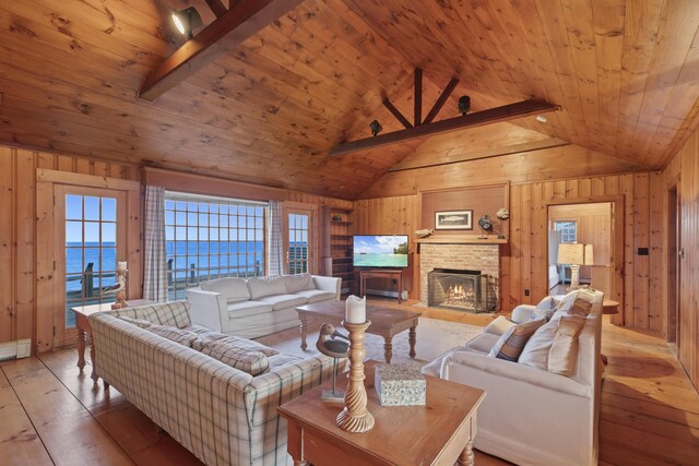 living room featuring wooden ceiling, lofted ceiling with beams, and a water view