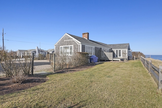 rear view of property with a lawn