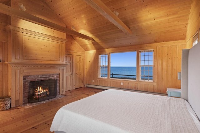 bedroom with wooden walls, wooden ceiling, a water view, and vaulted ceiling with beams