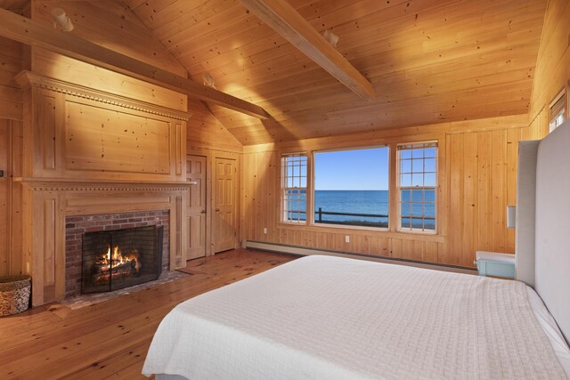 bedroom with wooden walls, wooden ceiling, a water view, and vaulted ceiling with beams