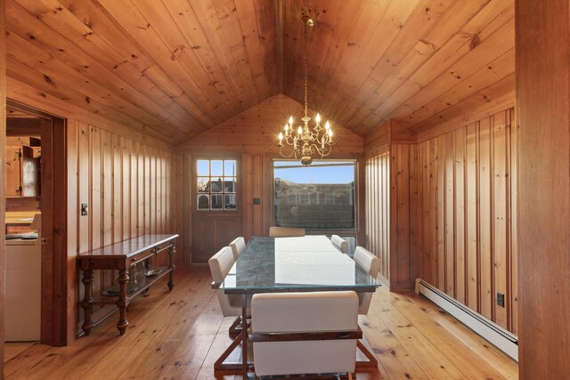 dining room featuring a baseboard radiator, light hardwood / wood-style flooring, lofted ceiling, and an inviting chandelier