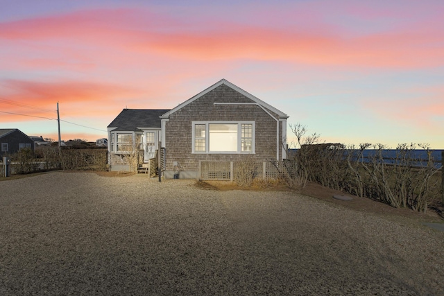 view of back house at dusk