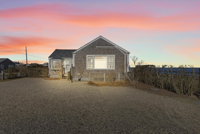 view of back house at dusk