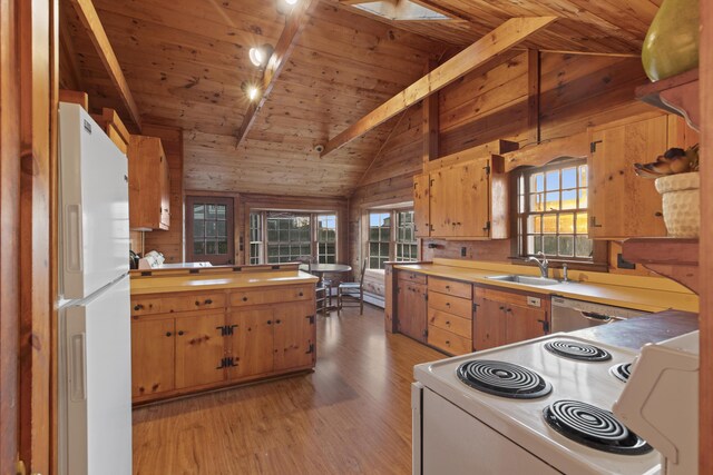 kitchen with sink, lofted ceiling with beams, wood ceiling, white appliances, and wooden walls