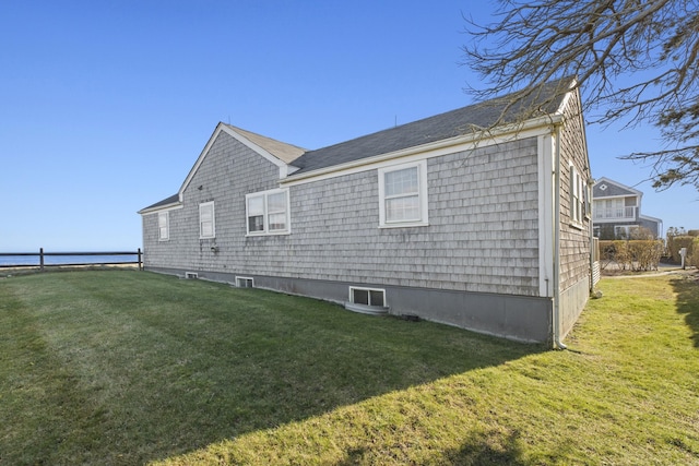 view of side of home with a yard