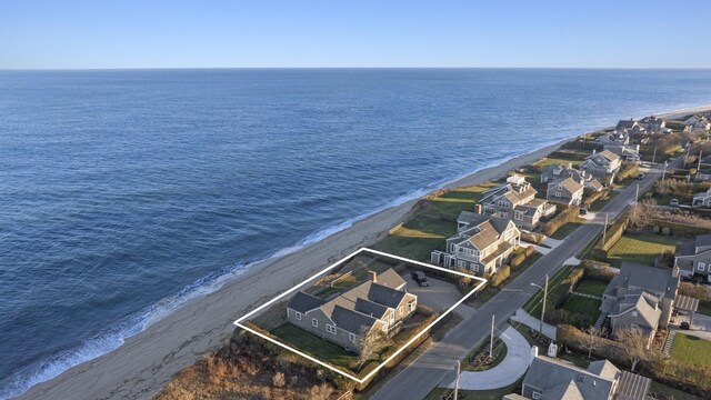 drone / aerial view with a water view and a view of the beach