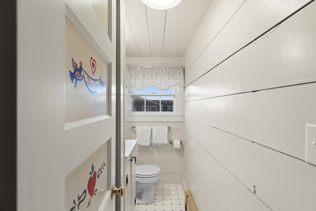 bathroom with vanity, toilet, ornamental molding, and a baseboard heating unit