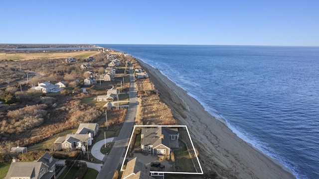 drone / aerial view with a beach view and a water view