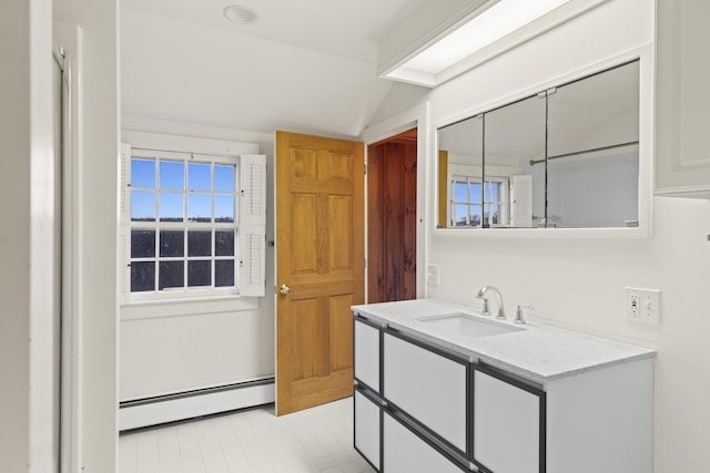 interior space with a baseboard radiator, sink, and vaulted ceiling