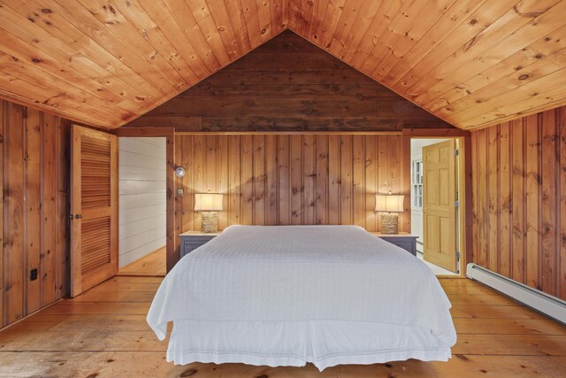 bedroom with wooden ceiling, a baseboard heating unit, lofted ceiling, and wooden walls