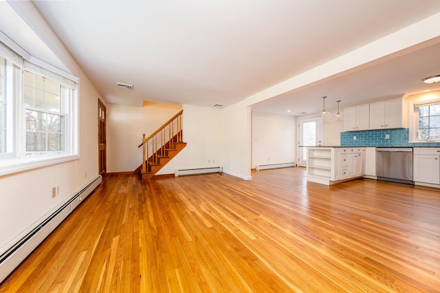 121 S Yarmouth Rd, Dennis, MA 02638 - unfurnished living room featuring baseboard heating, a baseboard radiator, and plenty of natural light
