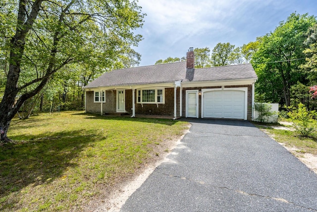 121 S Yarmouth Rd, Dennis, MA 02638 - single story home featuring a garage, asphalt driveway, a chimney, a front yard, and roof with shingles