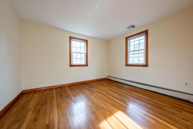 121 S Yarmouth Rd, Dennis, MA 02638 - unfurnished room featuring a baseboard radiator, plenty of natural light, wood finished floors, and baseboards