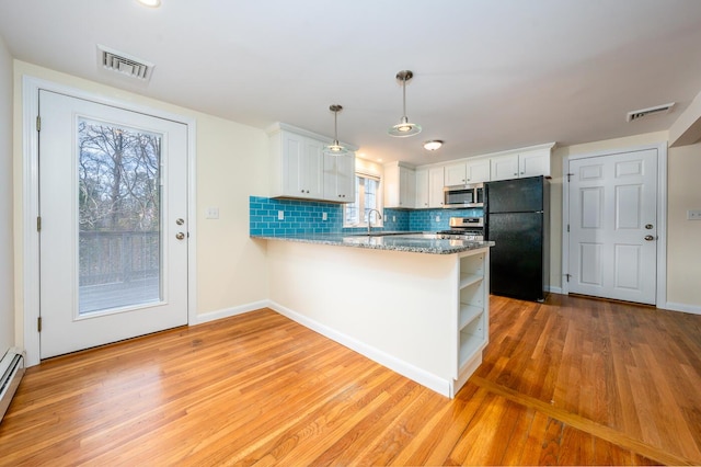 121 S Yarmouth Rd, Dennis, MA 02638 - kitchen featuring stainless steel appliances, light wood-style flooring, a peninsula, white cabinets, and open shelves