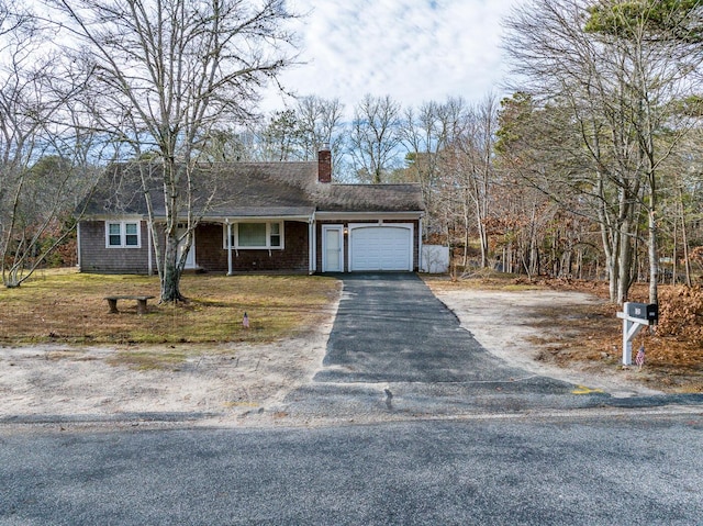 121 S Yarmouth Rd, Dennis, MA 02638 - view of front of property featuring a garage, asphalt driveway, a chimney, and a porch