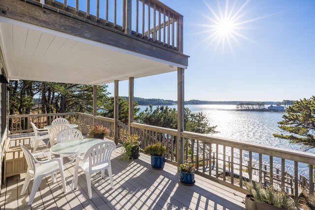 wooden terrace featuring a water view