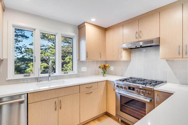 kitchen with light brown cabinetry, sink, decorative backsplash, and stainless steel appliances