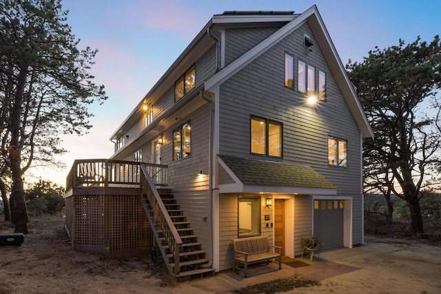 view of front of home featuring a wooden deck and a garage