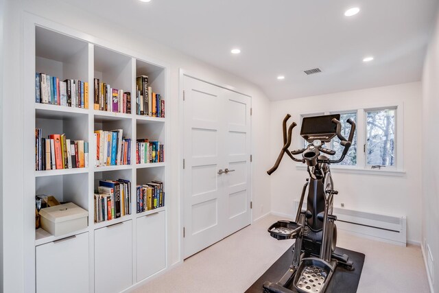 workout room with built in features and light colored carpet