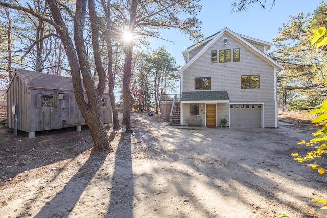 view of home's exterior with a wooden deck and a garage