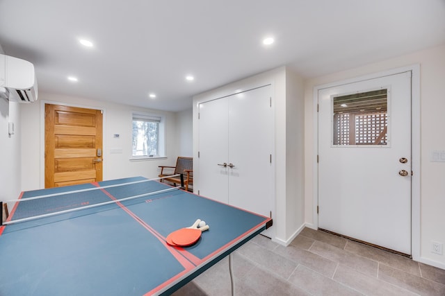 recreation room with an AC wall unit