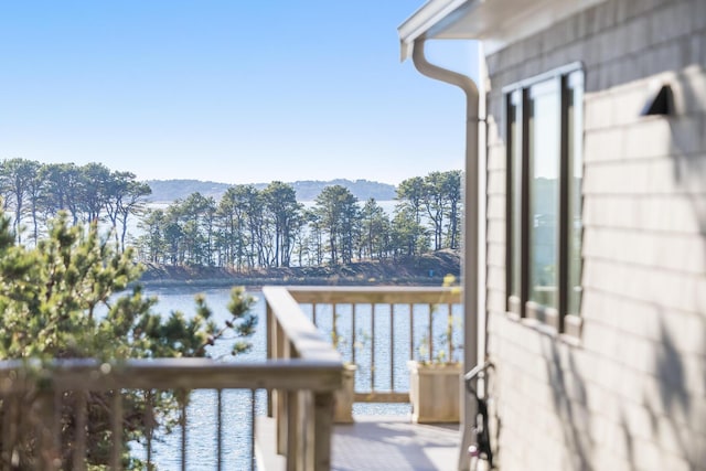 wooden terrace featuring a water view