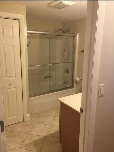 16 W Falmouth Hwy Unit 16, West Falmouth, MA 02540 - bathroom with vanity, enclosed tub / shower combo, and tile patterned flooring