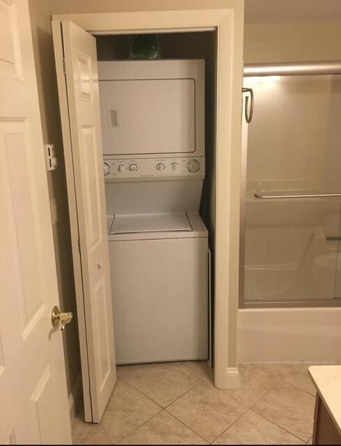 16 W Falmouth Hwy Unit 16, West Falmouth, MA 02540 - washroom with stacked washer / dryer and light tile patterned flooring