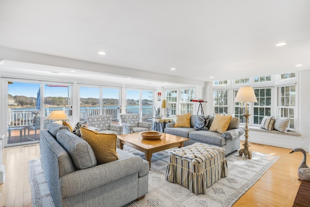 living area with light wood-style floors and recessed lighting