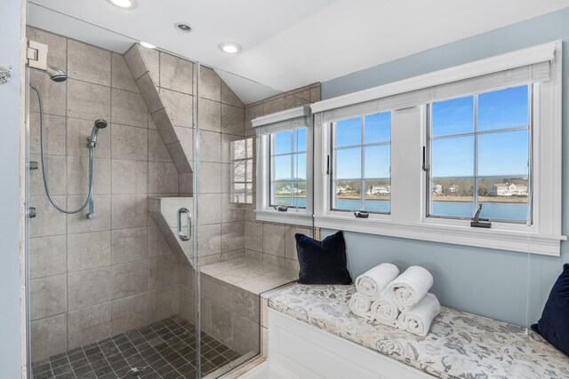 bathroom featuring a stall shower, a healthy amount of sunlight, vaulted ceiling, and recessed lighting