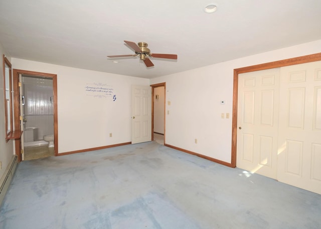 unfurnished bedroom featuring a closet, light carpet, baseboards, ensuite bathroom, and a baseboard heating unit