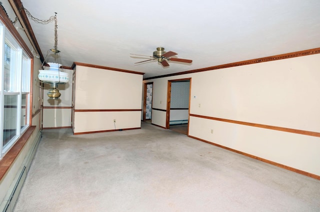 empty room with crown molding, baseboards, light colored carpet, and a baseboard radiator