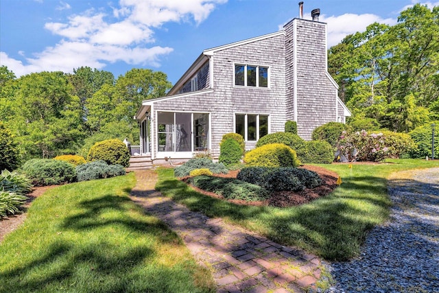 17 Claus Way, Marstons Mills, MA 02648 - rear view of property with a sunroom, a chimney, and a yard