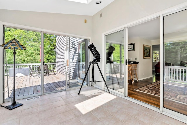 17 Claus Way, Marstons Mills, MA 02648 - workout room with plenty of natural light, tile patterned flooring, a skylight, baseboards, and a towering ceiling