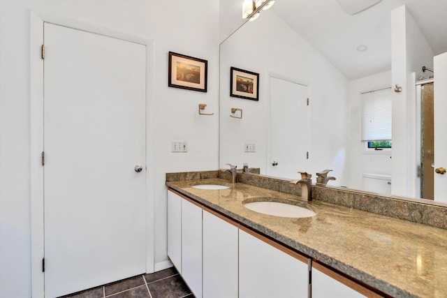 17 Claus Way, Marstons Mills, MA 02648 - full bathroom with double vanity, tile patterned floors, a shower with door, vaulted ceiling, and toilet